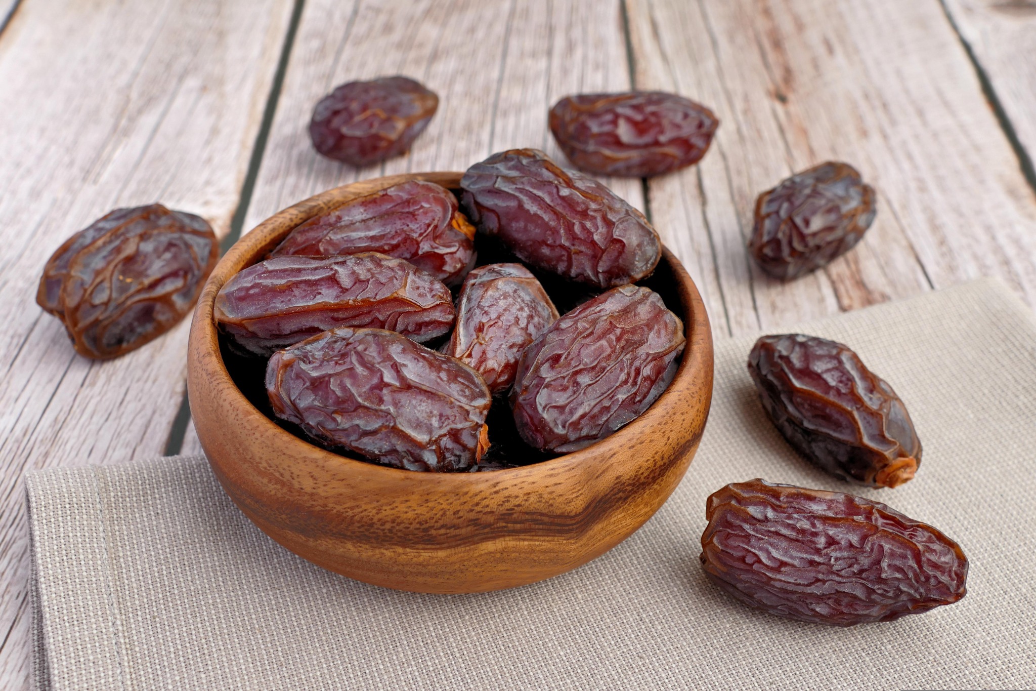 Whole Medjool dates in a wooden bowl